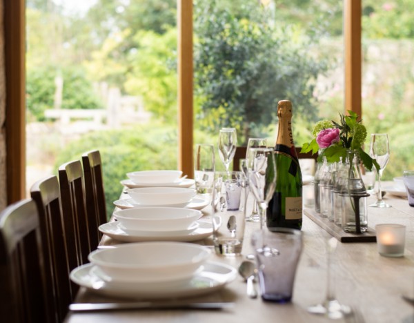 A set dining table with a view of the garden