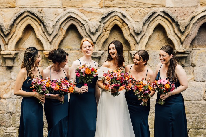 bride and bridesmaids outside Brinkburn Priory in Northumberland